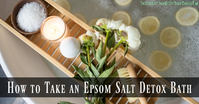 A detox bath with epsom salt and lemon slices.